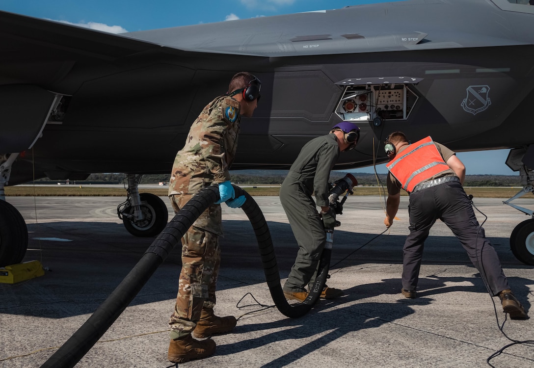 U.S. Marines, with Marine Corps Installations Pacific, and Airmen with the 355th Expeditionary Fighter Squadron, conduct hot- pit refueling training no Kadena Air Base, March 9, 2022. The training refined and enhanced the multiple aircraft platform skills of participating Marines, focusing on hot-pit refueling the F-35A Lightning II with limited time, simulating an operational environment. During hot-pit refueling, the aircraft maintains a running engine, which decreases the response time in an operational environment. (U.S. Marine Corps photo by Lance Cpl. Jonathan Beauchamp)