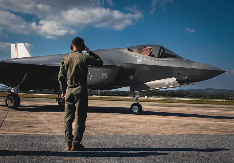 U.S. Marines, with Marine Corps Installations Pacific, salutes a pilot during hot-pit refueling training no Kadena Air Base, March 9, 2022. The training refined and enhanced the multiple aircraft platform skills of participating Marines, focusing on hot-pit refueling the F-35A Lightning II with limited time, simulating an operational environment. During hot-pit refueling, the aircraft maintains a running engine, which decreases the response time in an operational environment. (U.S. Marine Corps photo by Lance Cpl. Jonathan Beauchamp)