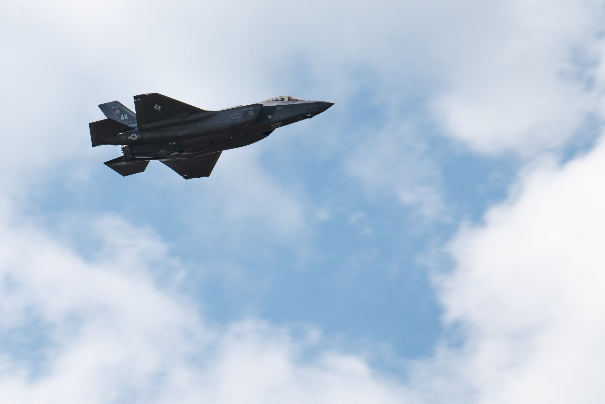 An F-35A Lightning II flies over the flightlinea at Kadena Air Base, Japan.