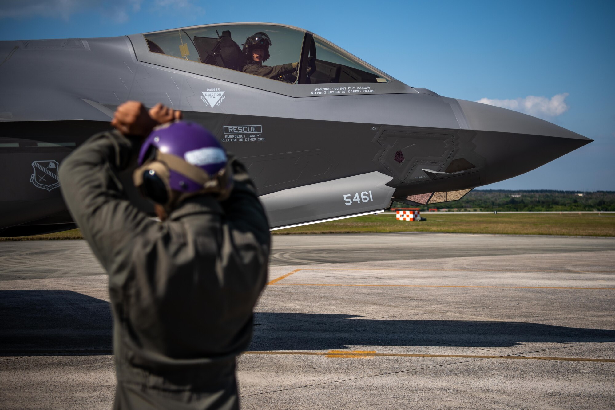 A Marine marshalls in an F-35A Lightning II.