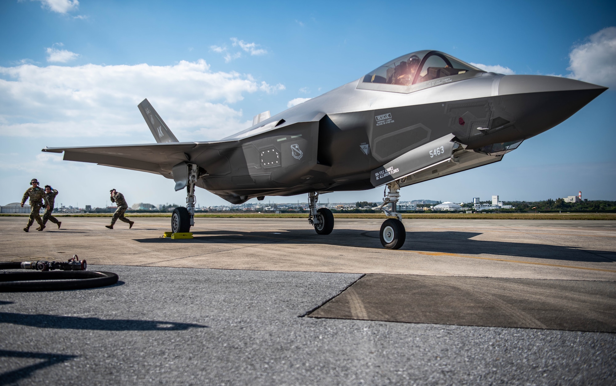 Airmen and Marines conduct hot pit refueling an F-35A Lightning II.