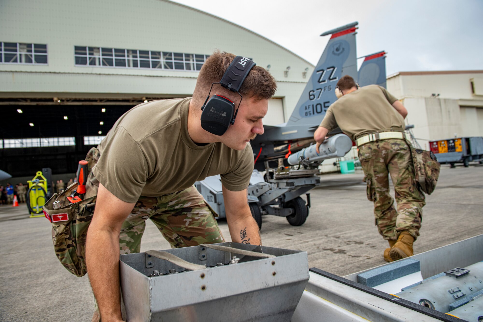 Airmen load a missile on an aircraft