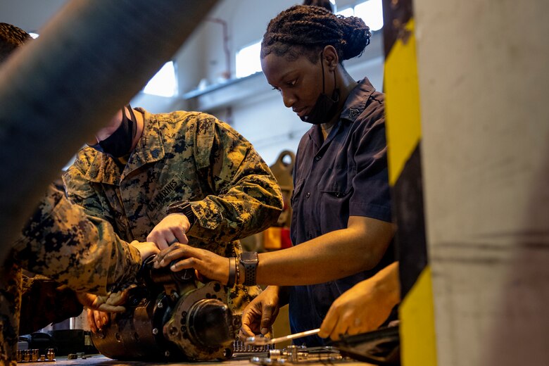 U.S. Marine Corps Cpl. Crystal Davis, an automotive maintenance technician with 3d Landing Support Battalion, Combat Logistics Regiment 3, 3d Marine Logistics Group, repairs a 7-ton truck starter on Camp Foster, Okinawa, Japan, Mar. 7, 2022. Davis, a Spanishtown; Jamaica native, joined the Marine Corps in 2019. Now at the rank of Corporal, she continues to be a diligent leader by striving to mirror her mother's guidance and wisdom towards her Marines. (U.S. Marine Corps photo by Lance Cpl. Jonathan Beauchamp)