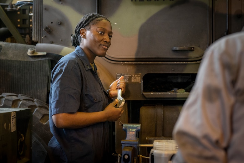 U.S. Marine Corps Cpl. Crystal Davis, an automotive maintenance technician with 3d Landing Support Battalion, Combat Logistics Regiment 3, 3d Marine Logistics Group holds a wrench while repairing a 7-ton truck starter on Camp Foster, Okinawa, Japan, Mar. 7, 2022. Davis, a Spanishtown, Jamaica native, joined the Marine Corps in 2019. Now at the rank of Corporal, she continues to be a diligent leader by striving to mirror her mother's guidance and wisdom towards her Marines. (U.S. Marine Corps photo by Lance Cpl. Jonathan Beauchamp)