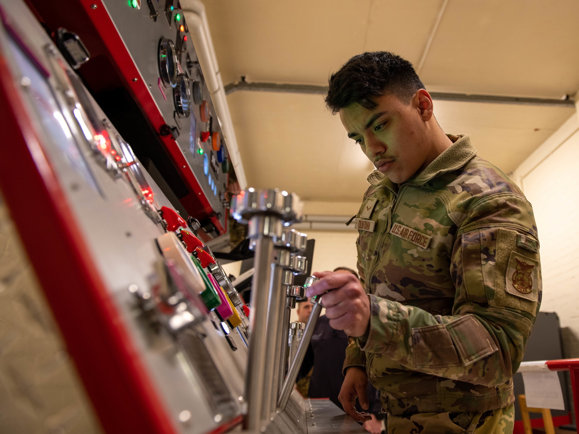 Fire fighter operating a pump simulator