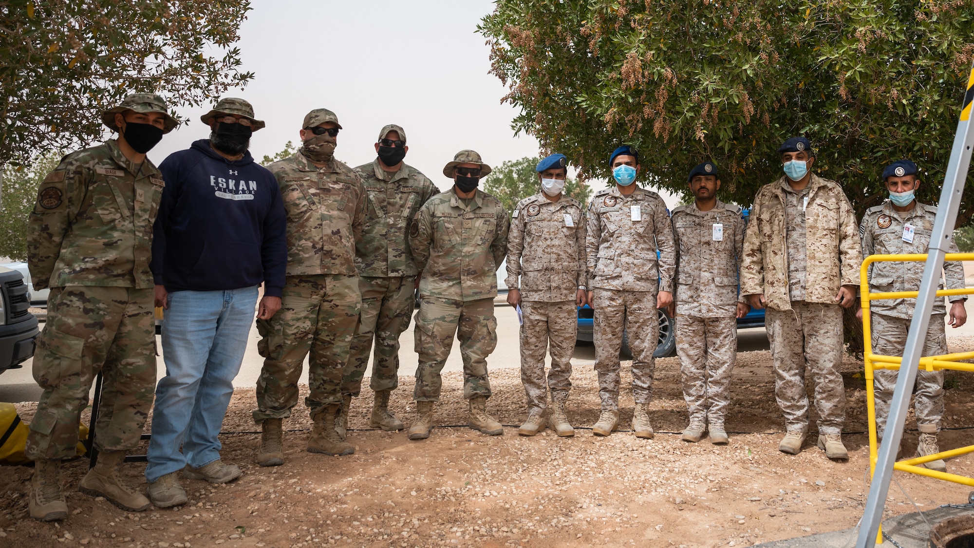 Service members from the U.S. Air Force and Royal Saudi Air Force pose for a group photo at Prince Sultan Air Base, Kingdom of Saudi Arabia, March 17, 2022. The two services performed a fiber optic repair where they fused 24 fiber optic strands together. (U.S. Air Force photo by Senior Airman Jacob B. Wrightsman)