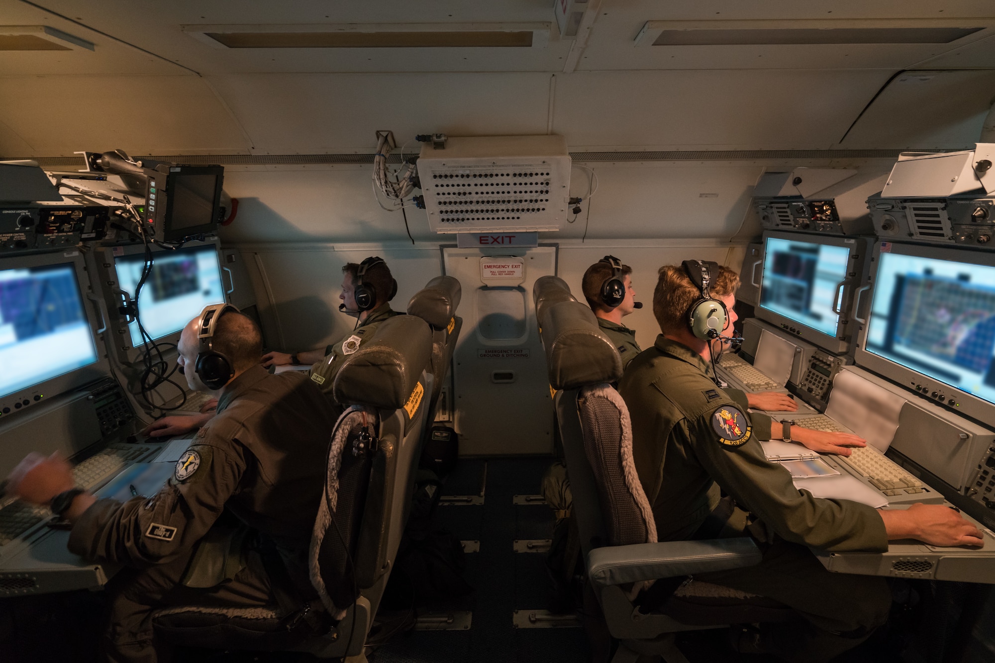 U.S. Air Force aircrew members from the 116th Air Control Wing (ACW), Georgia Air National Guard, monitor surveillance data while flying a night mission aboard an E-8C Joint STARS, Robins Air Force Base, Ga., July 13, 2017. Team JSTARS, consisting of the 116th ACW, active-duty 461st ACW and Army JSTARS, provides joint airborne command and control, intelligence, surveillance, and reconnaissance support over land and water to combatant commanders around the globe. The Total Force Integration unit operates the world’s only Joint STARS weapon system based out of Robins Air Force Base. (U.S. Air National Guard photo by Senior Master Sgt. Roger Parsons) (Portions of the photo have been blurred for security and privacy concerns)