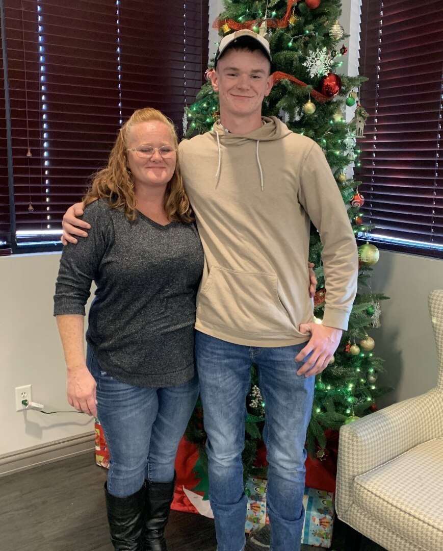 Spc. Tyler Watters, assigned to the 404th Maneuver Enhancement Brigade, with his mother. Watters and two other volunteers helped save the life of a man who was severely injured in a single-vehicle accident on Interstate 55 March 13, 2022.n Lincoln.