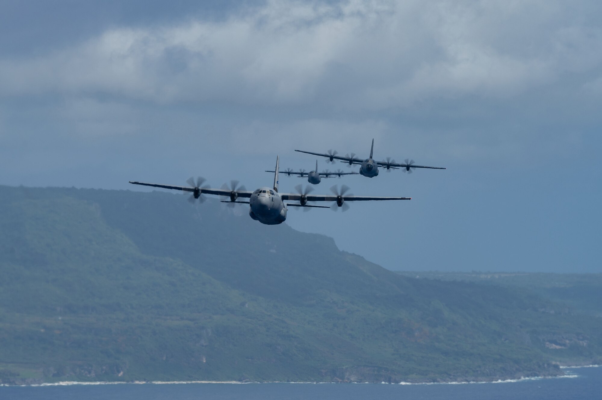 Three C-130J Super Hercules fly during exercise Cope North 22 over Tinian in the Northern Mariana Islands, Feb. 5, 2022.