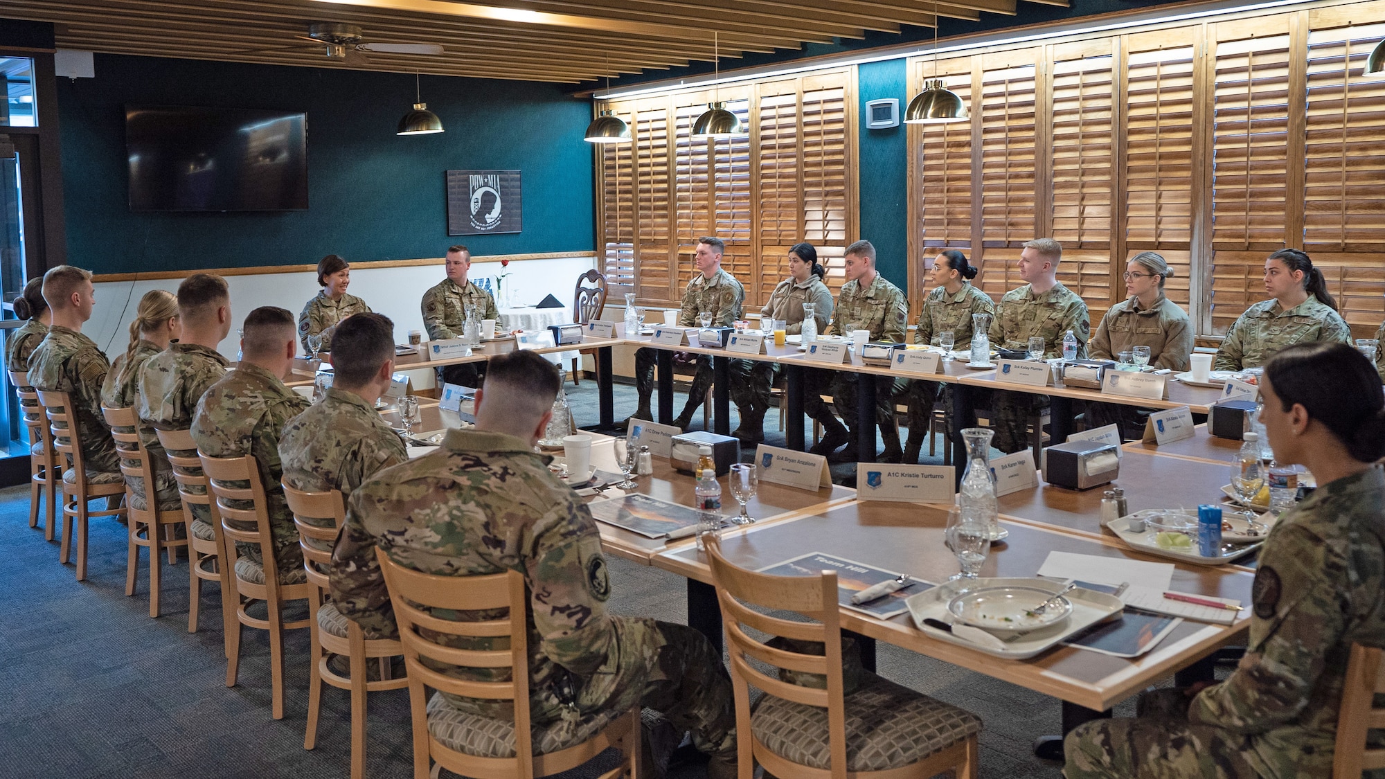 Airmen sit around tables with Chief Master Sergeant of the Air Force JoAnne S. Bass at the head.