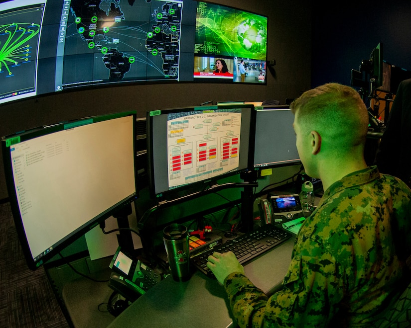 A Marine operates a computer.
