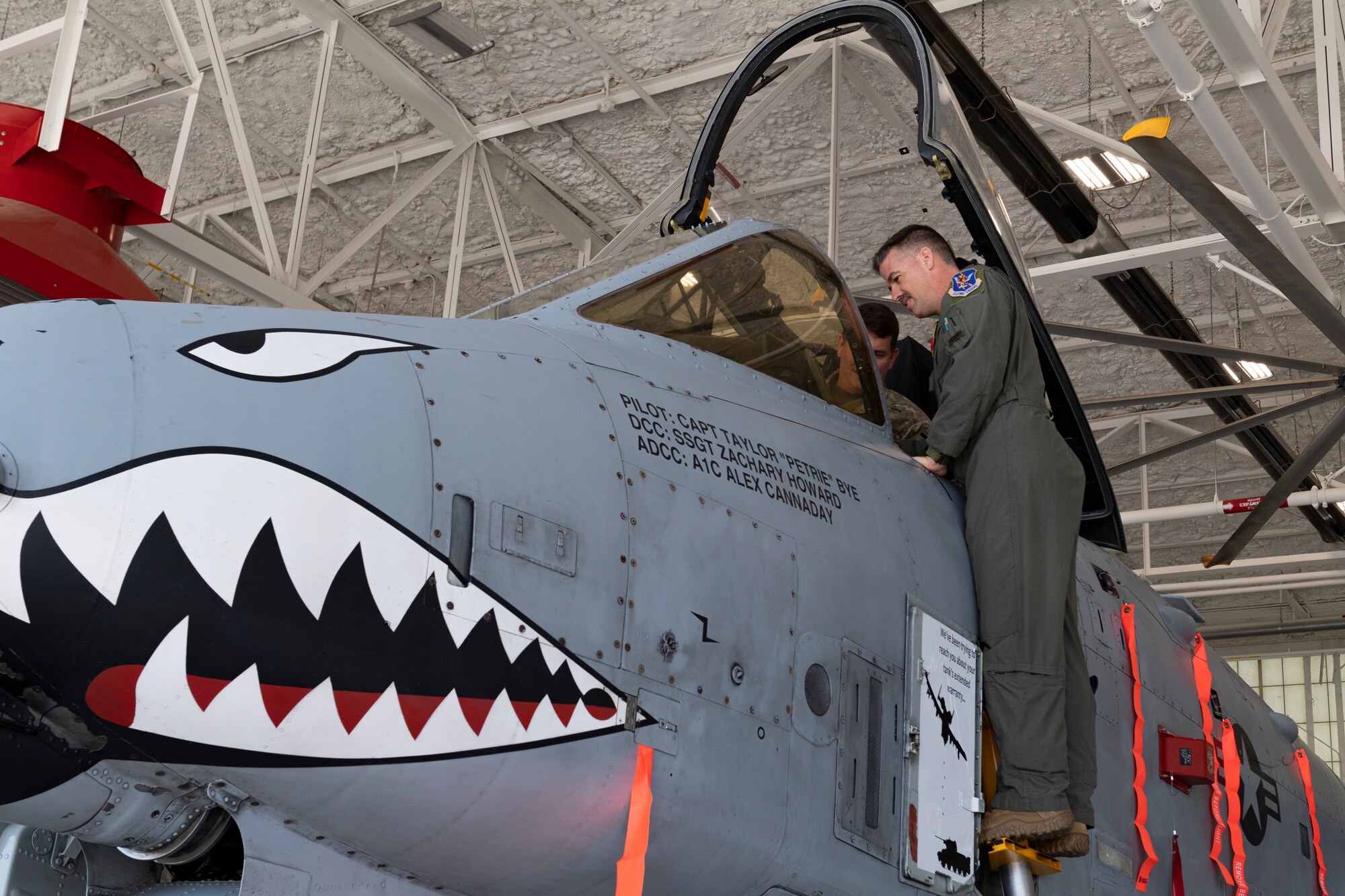 Photo of an Airman inspecting the cockpit of an aircraft
