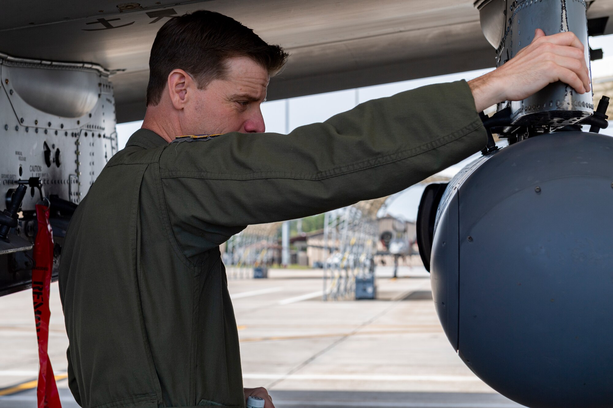 Photo of an Airman inspecting an aircraft