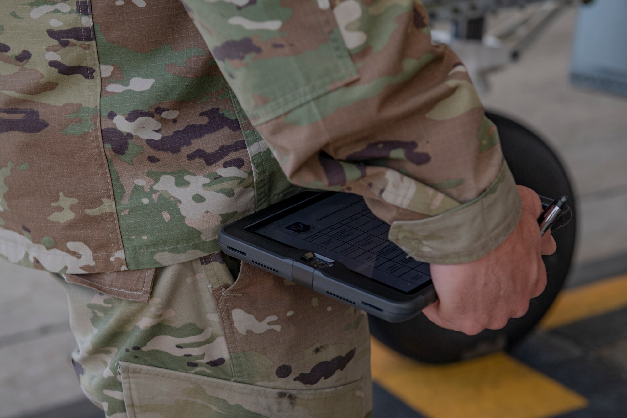 Photo of an Airman holding an electronic tablet