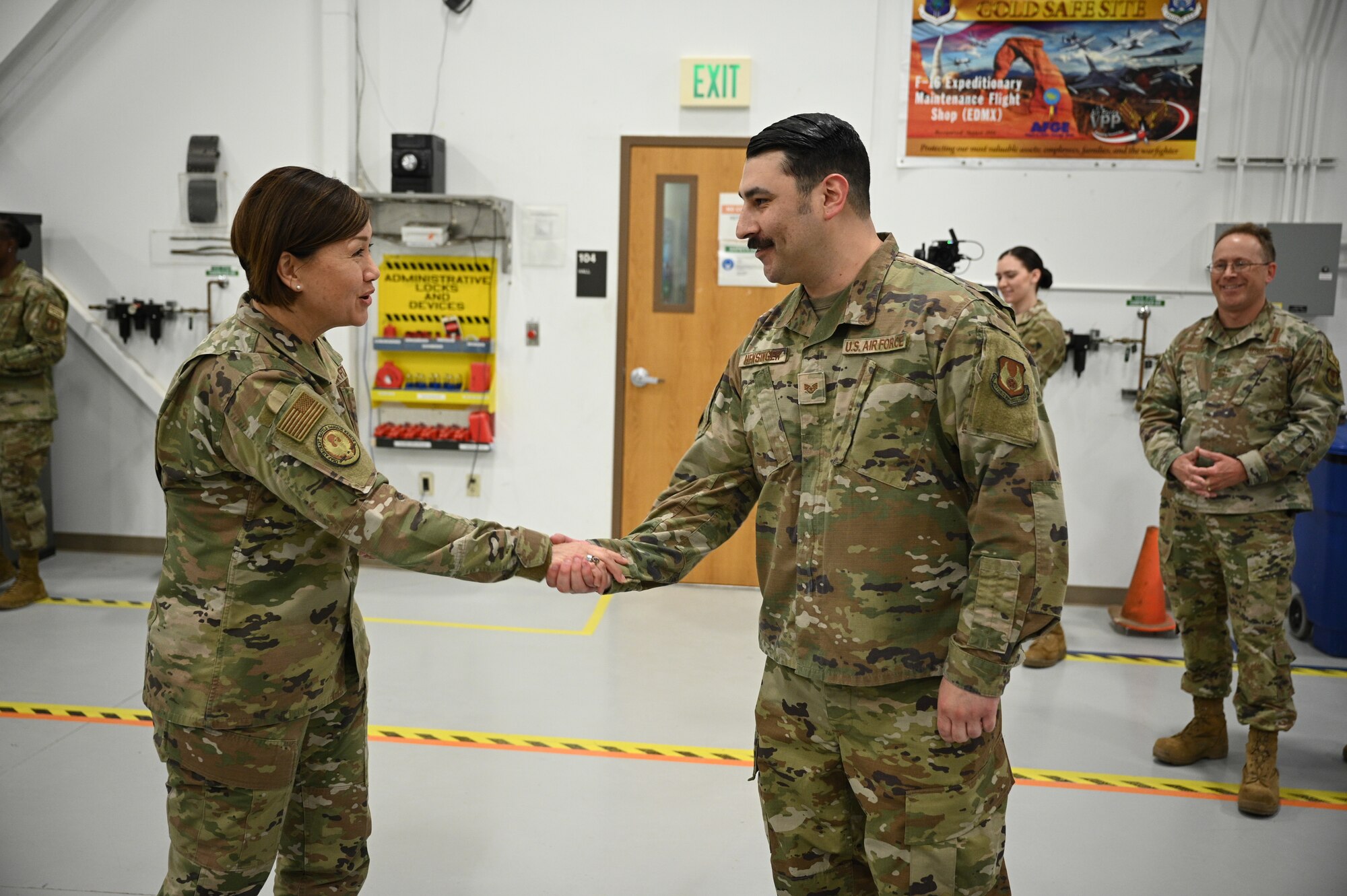 Chief Master Sgt. of the Air Force JoAnne S. Bass coins Staff Sgt. Spencer Hensinger.