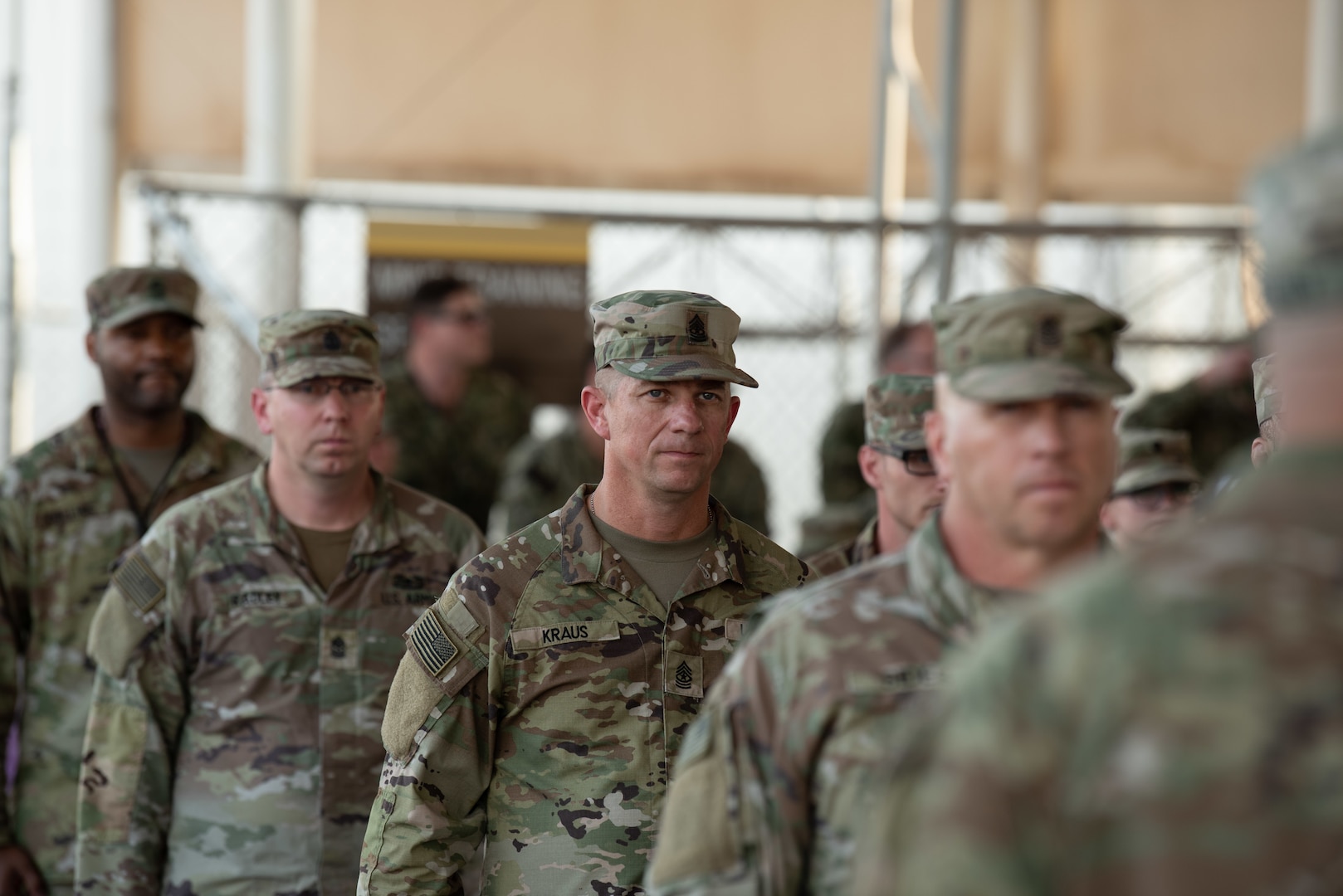 Members of the 404th Maneuver Enhancement Brigade wait to receive their combat patch, a military milestone earned while serving in hostile conditions, March 17, 2022.