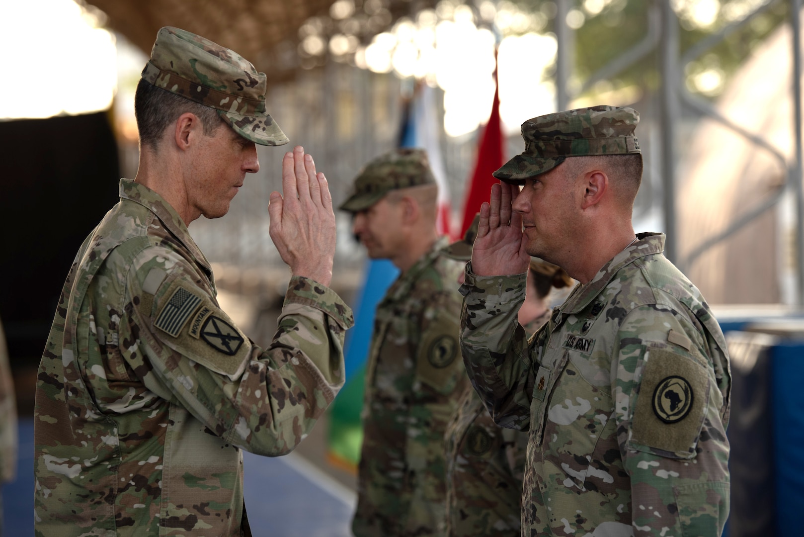 Maj. Gen. William Zana, commanding general of Combined Joint Task Force - Horn of Africa (CJTF-HOA), returns a salute to a member of the 404th Maneuver Enhancement Brigade after placing a newly earned combat patch on the Soldier,