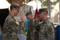Maj. Gen. William Zana, commanding general of Combined Joint Task Force - Horn of Africa (CJTF-HOA), returns a salute to a member of the 404th Maneuver Enhancement Brigade after placing a newly earned combat patch on the Soldier,