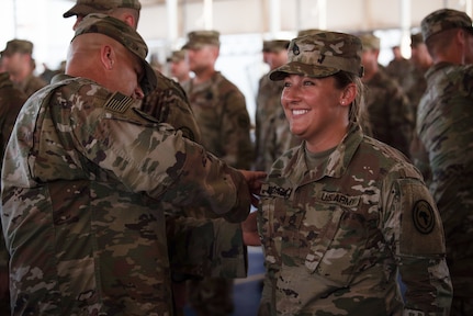 Members of the 404th Maneuver Enhancement Brigade receive their combat patch, a military milestone earned while serving in hostile conditions, March 17, 2022.