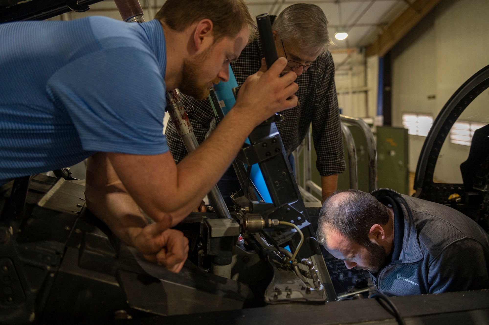 Engineers contracted by the U.S. Air Force check on ejection seat components before ejection seat installation on an F-15E Strike Eagle at Seymour Johnson Air Force Base, North Carolina, March 14, 2022. The cockpit of the Strike Eagle has to have the ejection seat removed and prepared for installation of the new ejection seat. The Advanced Concept Ejection Seat 5 will replace the F-15E's older ACES II, which is used in many other aircraft in the U.S. Air Force’s arsonal. (U.S. Air Force photo by Senior Airman Kevin Holloway)