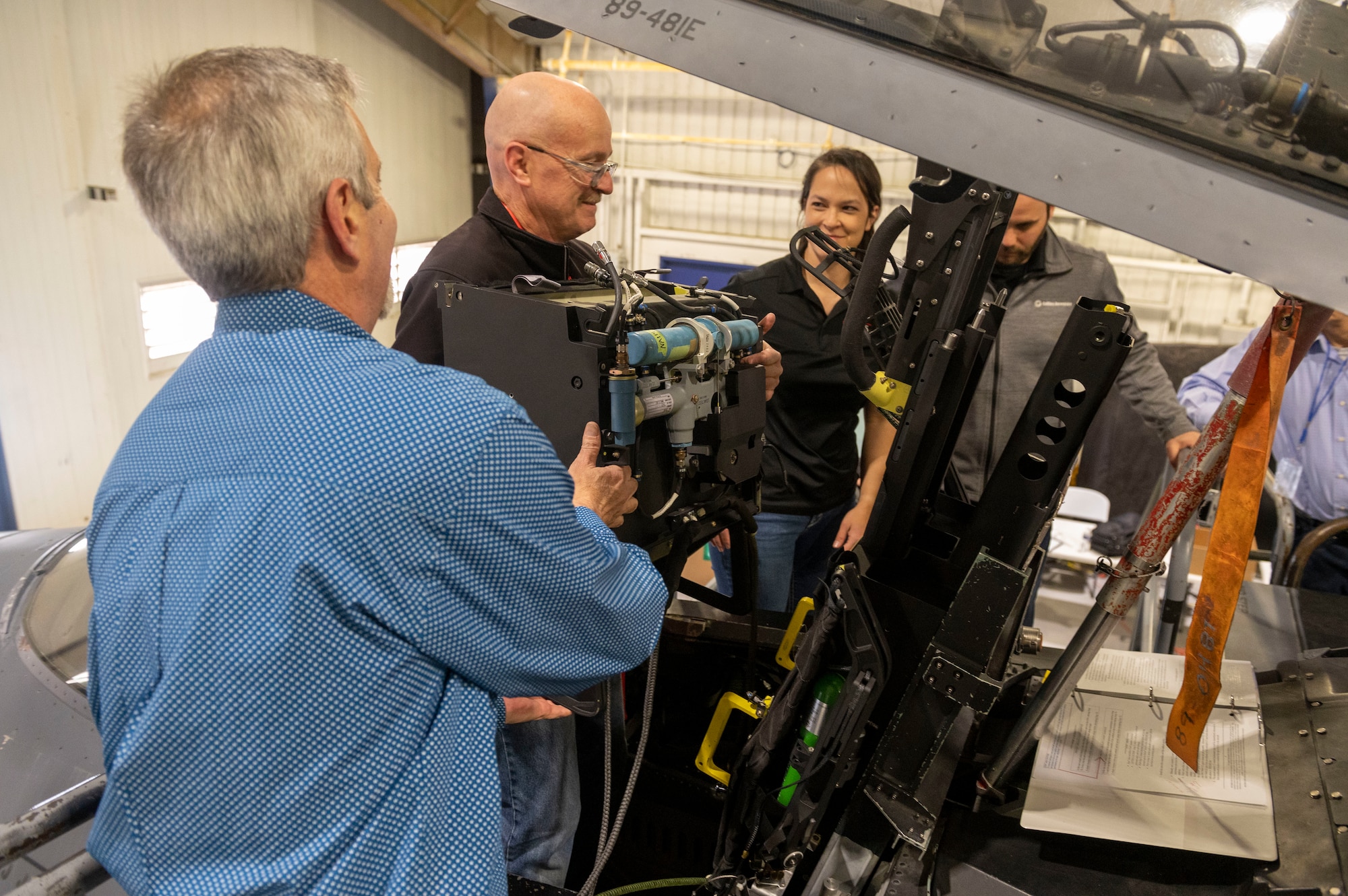 Engineers install modular ejection seat components during an ejection seat installation on an F-15E Strike Eagle at Seymour Johnson Air Force Base, North Carolina, March 14, 2022. Modular seats were engineered to save time by not having to uninstall the Strike Eagle canopy before the ejection seat installation.  The Advanced Concept Ejection Seat 5 will replace the F-15E's older ACES II  which is used in many other aircraft in the U.S. Air Force’s arsonal. (U.S. Air Force photo by Senior Airman Kevin Holloway)
