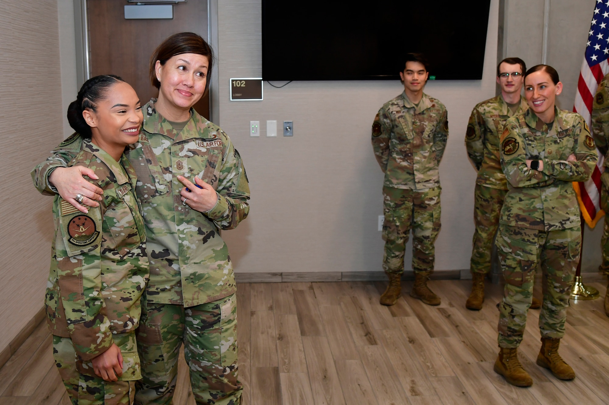 Senior Airman Jayauna Tyler, 75th Operations Support Squadron, is recognized by Chief Master Sgt. of the Air Force JoAnne S. Bass her for outstanding performance during a base visit at Hill Air Force Base, Utah, March 15, 2022. During her visit, Bass met with Airmen and Guardians to learn how Hill AFB units enhances readiness for the nation. (U.S. Air Force photo by Todd Cromar)