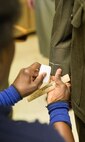 Tailors mark each service and dress uniform to ensure proper fit.