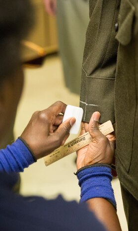 Tailors mark each service and dress uniform to ensure proper fit.