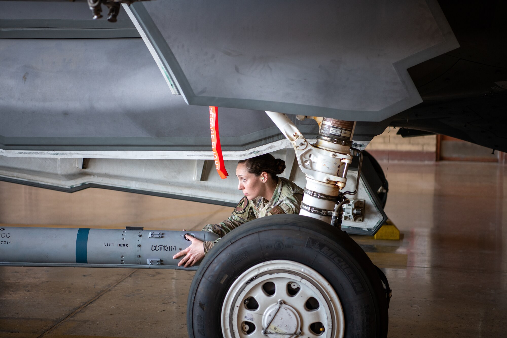 Senior Airman Abigail Halpert, 63rd Aircraft Maintenance Unit weapons load crew member, loads munitions onto an F-35A Lightning II during the Women of Weapons Load Exhibition March 11, 2022, at Luke Air Force Base, Arizona. The event was held in celebration of Women’s History Month to exemplify a culture of diversity and inclusion across the 56th Maintenance Group. (U.S. Air Force photo by Senior Airman Phyllis Jimenez)