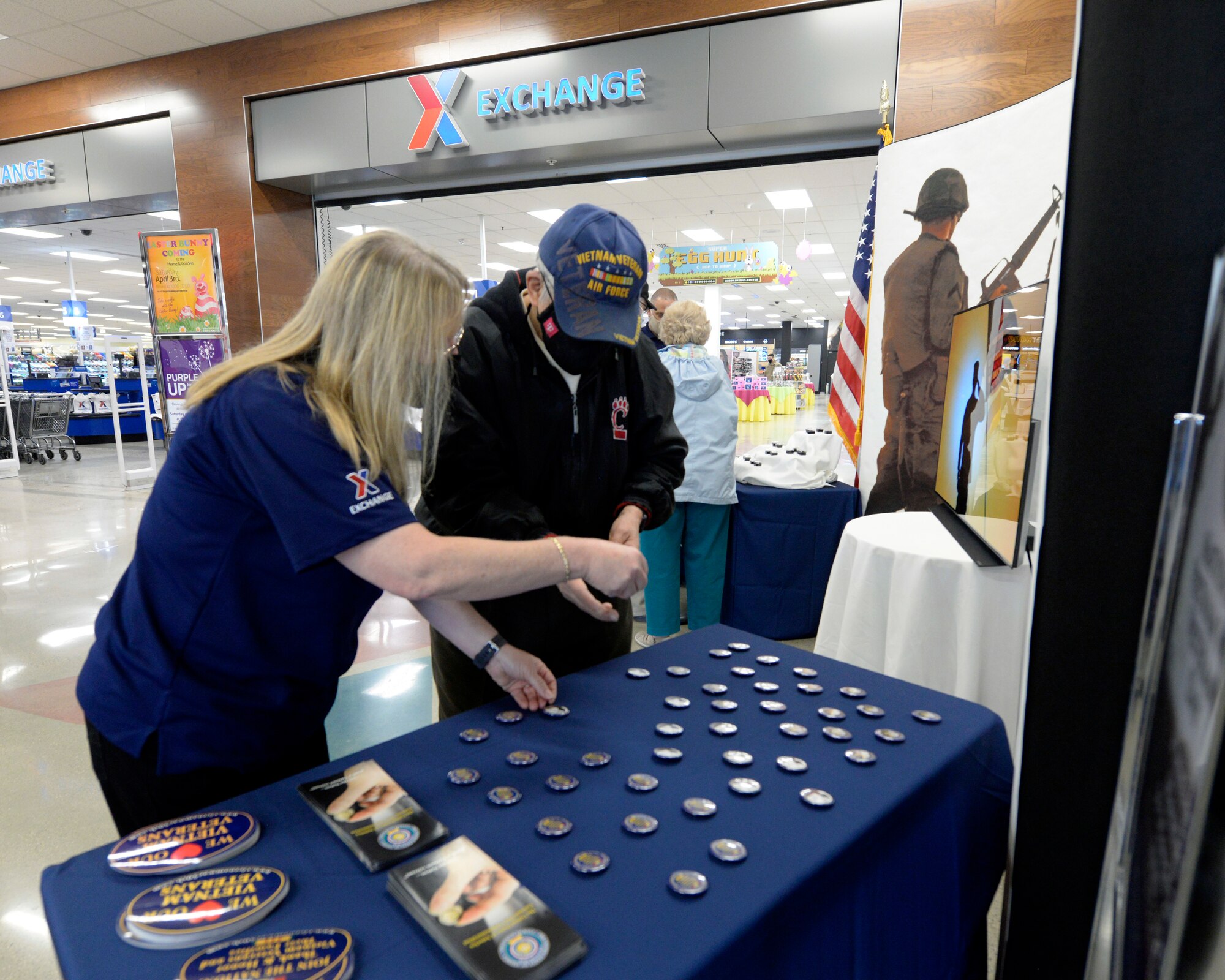 Sandra Church, acting store manager at the Base Exchange, presents buttons to Vietnam War veteran Paul Swisshelm at Wright-Patterson Air Force Base on March 29, 2021, National Vietnam War Veterans Day. Managers at the Base Exchange presented Vietnam veterans with a lapel pins, and buttons to recognize, thank and honor veterans who served as they entered the store.