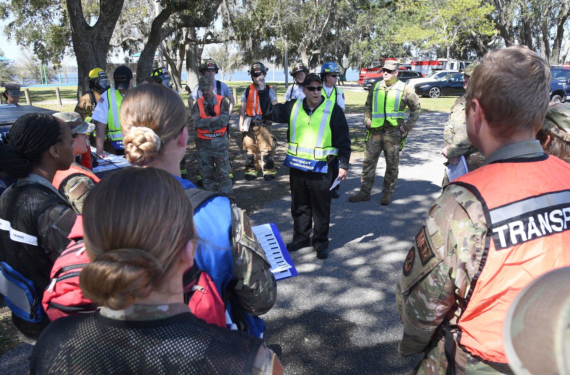 James Donnett, 81st Civil Engineering Squadron fire chief, discusses the action plan with emergency response team members during an Antiterrorism, Force Protection and Chemical, Biological, Radiological, Nuclear exercise at Keesler Air Force Base, Mississippi, March 17, 2022. The exercise tested the base's ability to respond to and recover from a mass casualty event. (U.S. Air Force photo by Kemberly Groue)