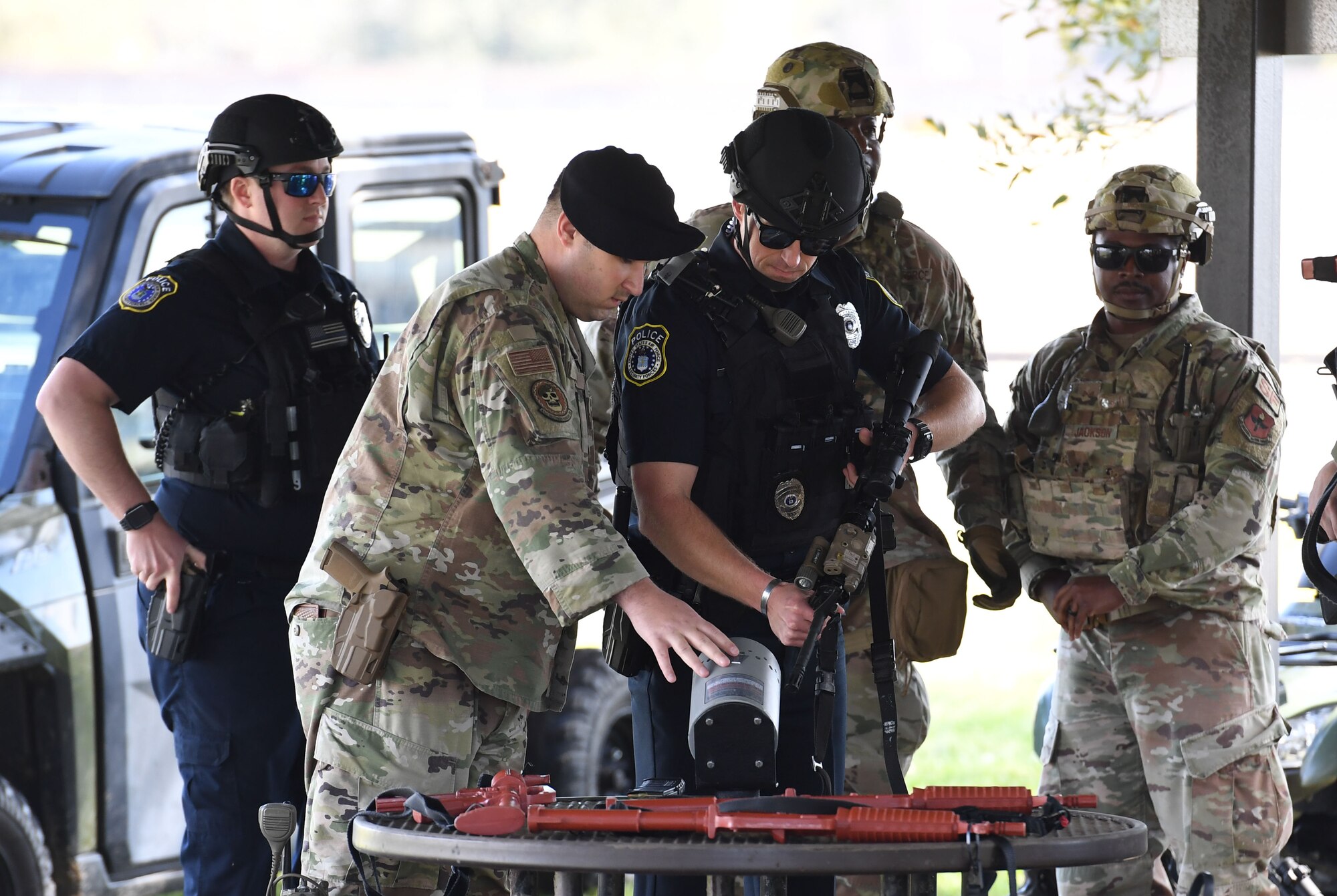 Members of the 81st Security Forces Squadron make a weapons exchange during an Antiterrorism, Force Protection and Chemical, Biological, Radiological, Nuclear exercise at Keesler Air Force Base, Mississippi, March 17, 2022. The exercise tested the base's ability to respond to and recover from a mass casualty event. (U.S. Air Force photo by Kemberly Groue)