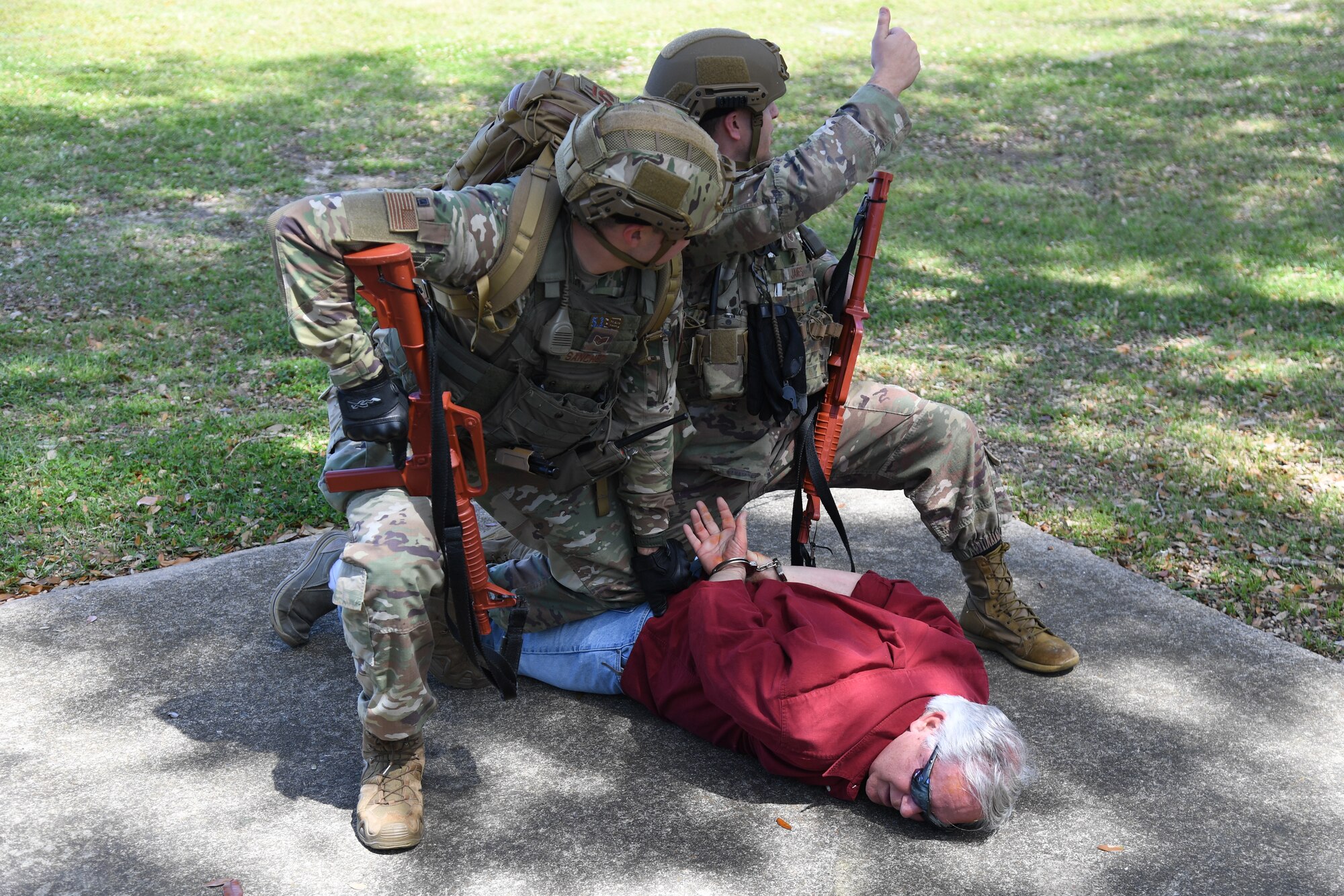 Members of the 81st Security Forces Squadron apprehend Mike Gulino, 81st Training Support Squadron director of training, as he portrays the perpetrator during an Antiterrorism, Force Protection and Chemical, Biological, Radiological, Nuclear exercise at Keesler Air Force Base, Mississippi, March 17, 2022. The exercise tested the base's ability to respond to and recover from a mass casualty event. (U.S. Air Force photo by Kemberly Groue)