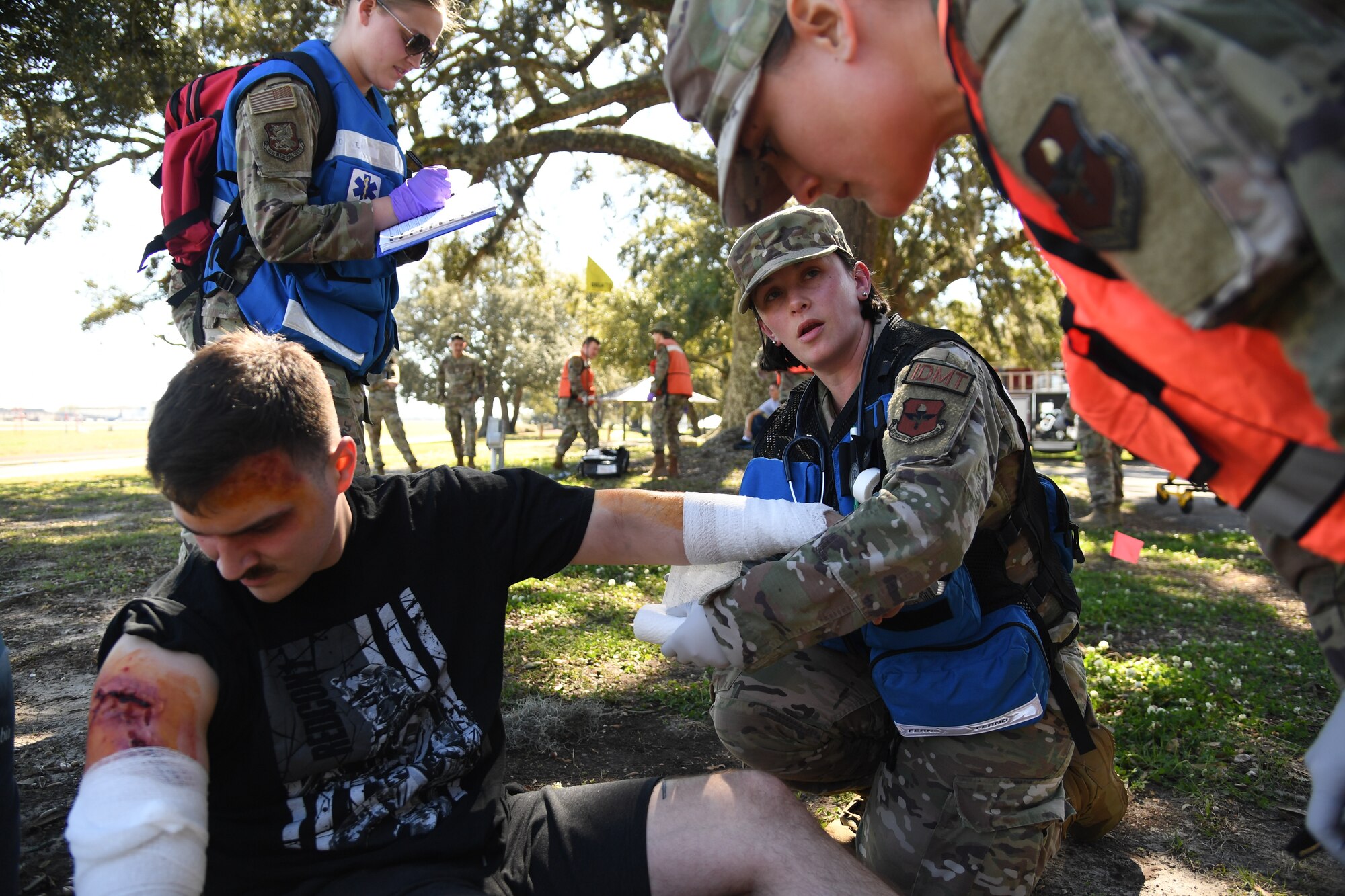 Members of the 81st Medical Group provide medical treatment to simulated victims during an Antiterrorism, Force Protection and Chemical, Biological, Radiological, Nuclear Exercise at Keesler Air Force Base, Mississippi, March 17, 2022. The exercise tested the base's ability to respond to and recover from a mass casualty event. (U.S. Air Force photo by Kemberly Groue)