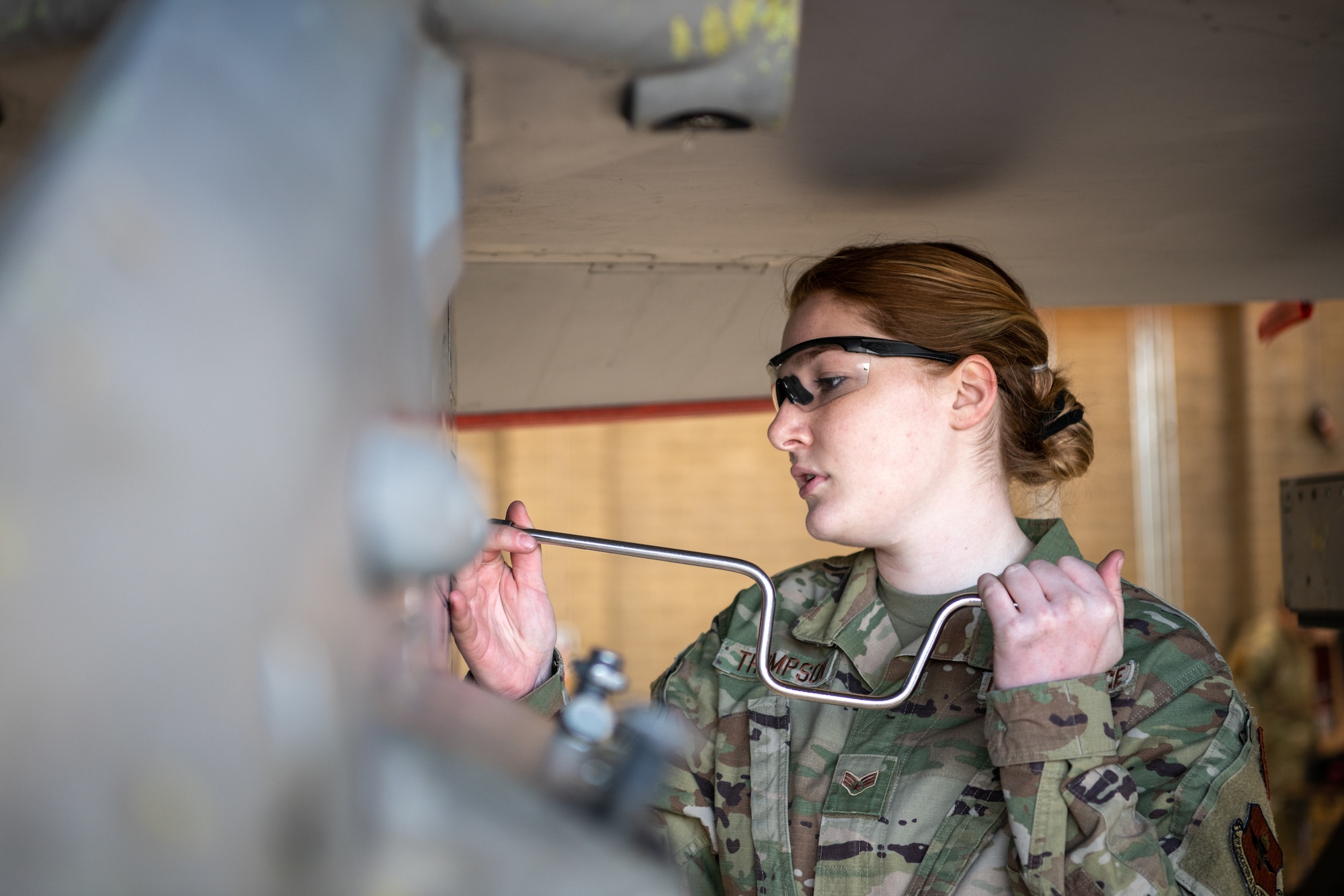 Senior Airman Kira Tompson, 309th Aircraft Maintenance Unit weapons load crew member,  prepares an F-16D Fighting Falcon for a munitions load during the Women of Weapons Load Exhibition March 11, 2022, at Luke Air Force Base, Arizona. The event was held in celebration of Women’s History Month to exemplify a culture of diversity and inclusion across the 56th Maintenance Group. (U.S. Air Force photo by Senior Airman Phyllis Jimenez)