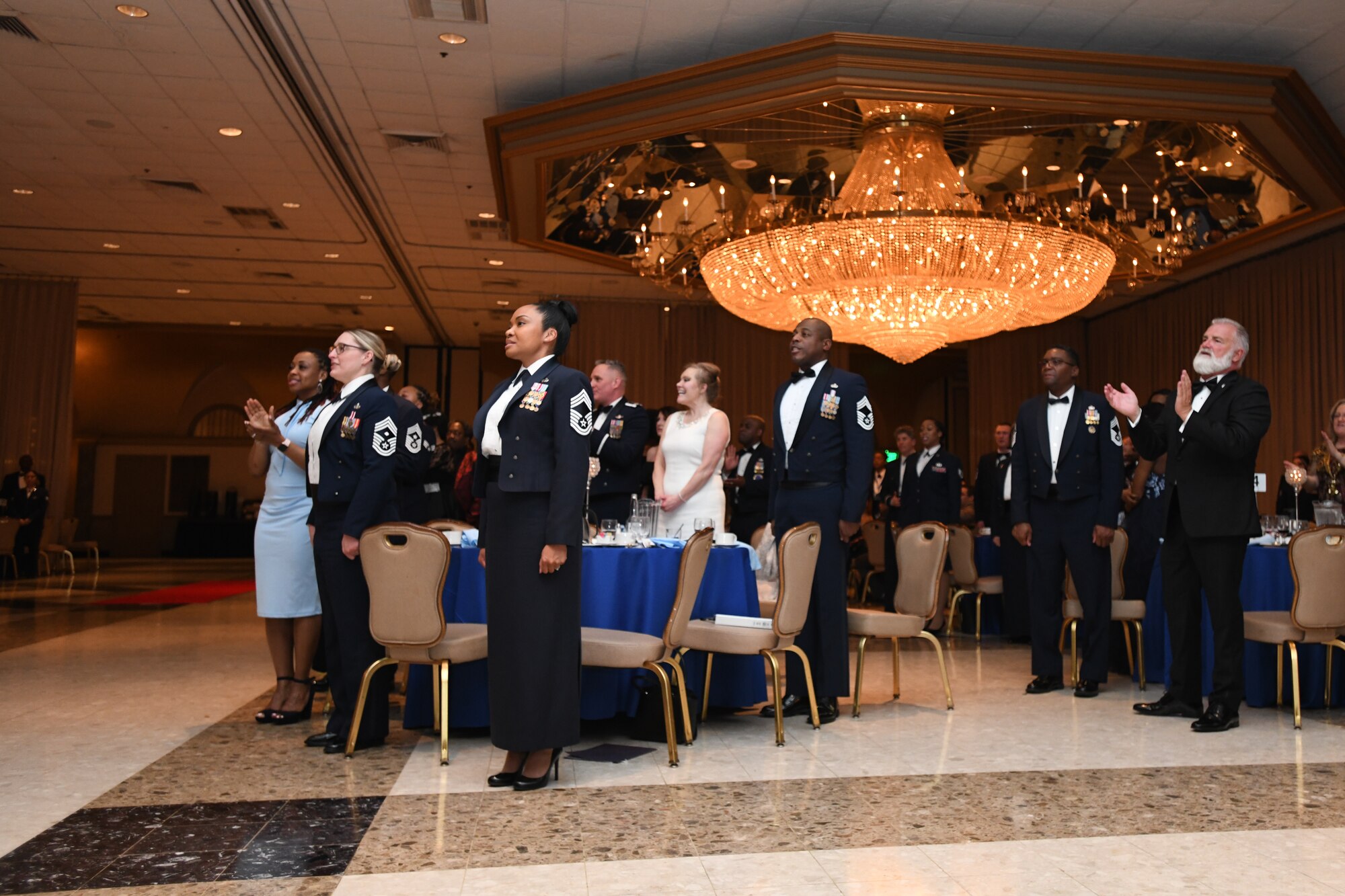 Airmen and their families participate in singing  the U.S. Air Force Song during a Chief Recognition Ceremony at Martin’s Crosswinds in Greenbelt, Md., March 18, 2022.