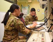 Missileers sit at a control console