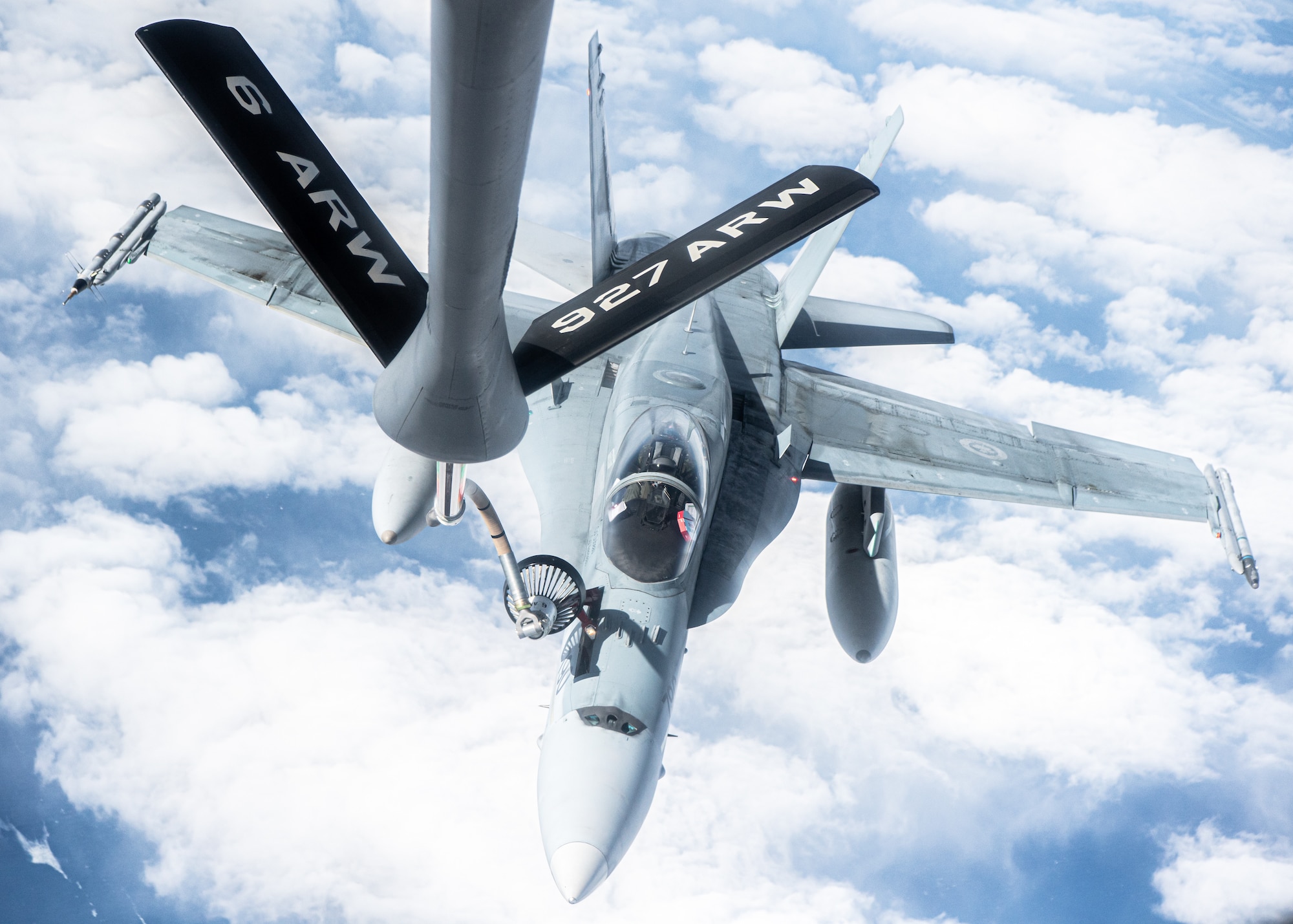 A KC-135 Stratotanker aircraft assigned to the 6th Air Refueling Wing provides aerial refueling for a CF-18 Hornet aircraft assigned to the 433rd Tactical Fighter Squadron in support of North American Aerospace Defense Command's (NORAD) Operation Noble Defender (OND), March 16, 2022.