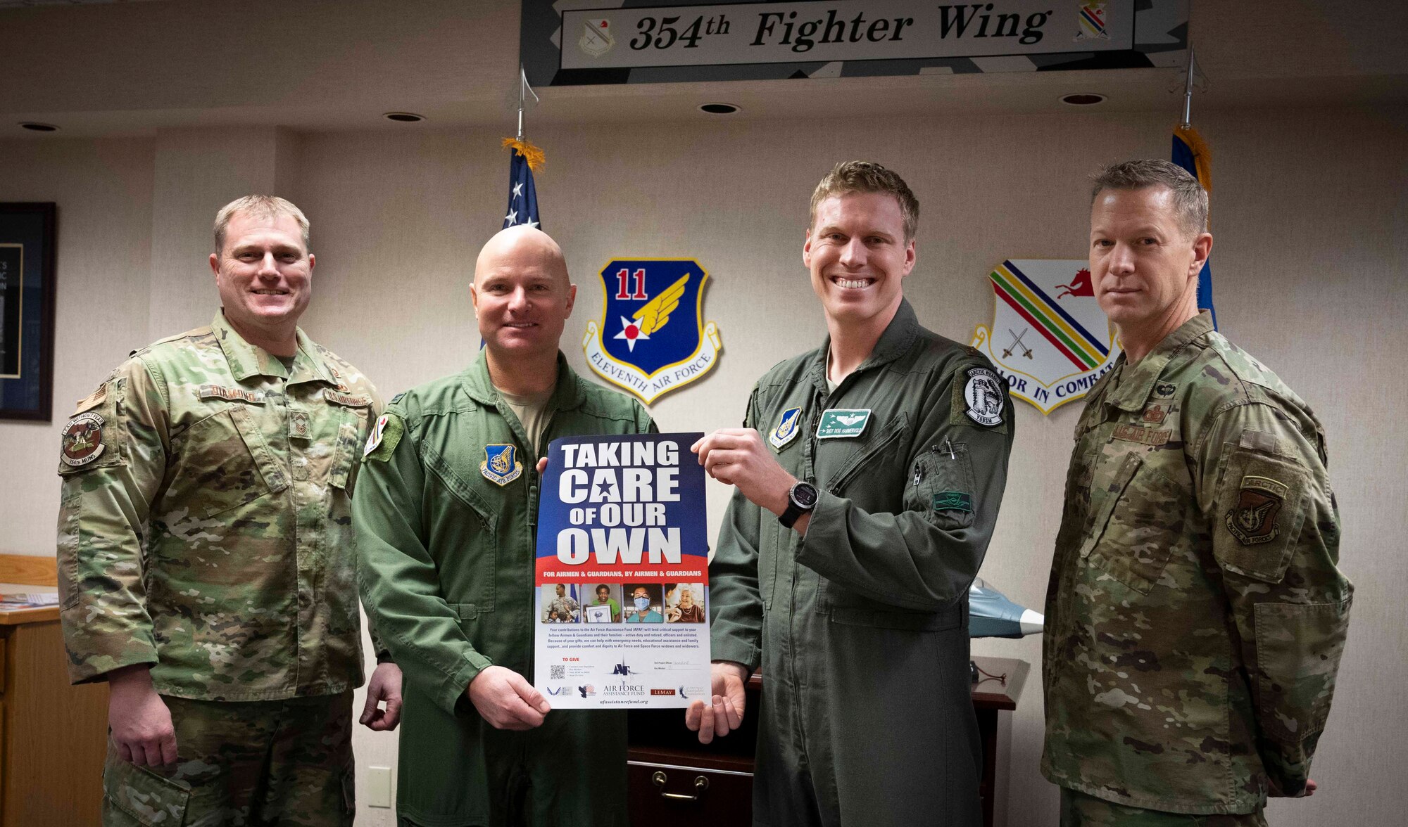 Leadership assigned to the 354th Fighter Wing and Air Force Assistance Fund (AFAF) representatives pose for a photo at Eielson Air Force Base, Alaska, March 21, 2022.