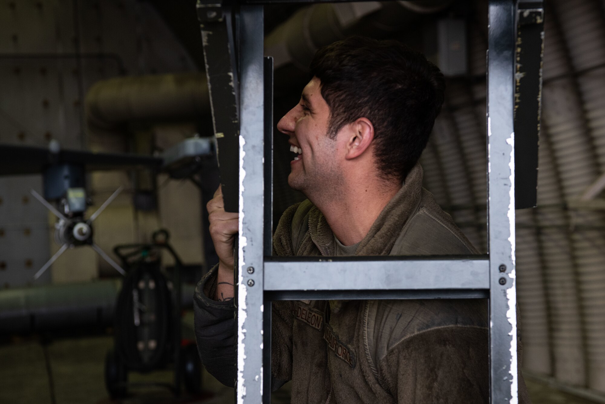 Tech. Sgt. Jose Corral DeLeon, 36th Aircraft Maintenance Unit, cannibalization manager, prepares to set up a ladder for a pilot to climb out of an F-16 Fighting Falcon after flying at Osan Air Base, Republic of Korea, March 18, 2022.