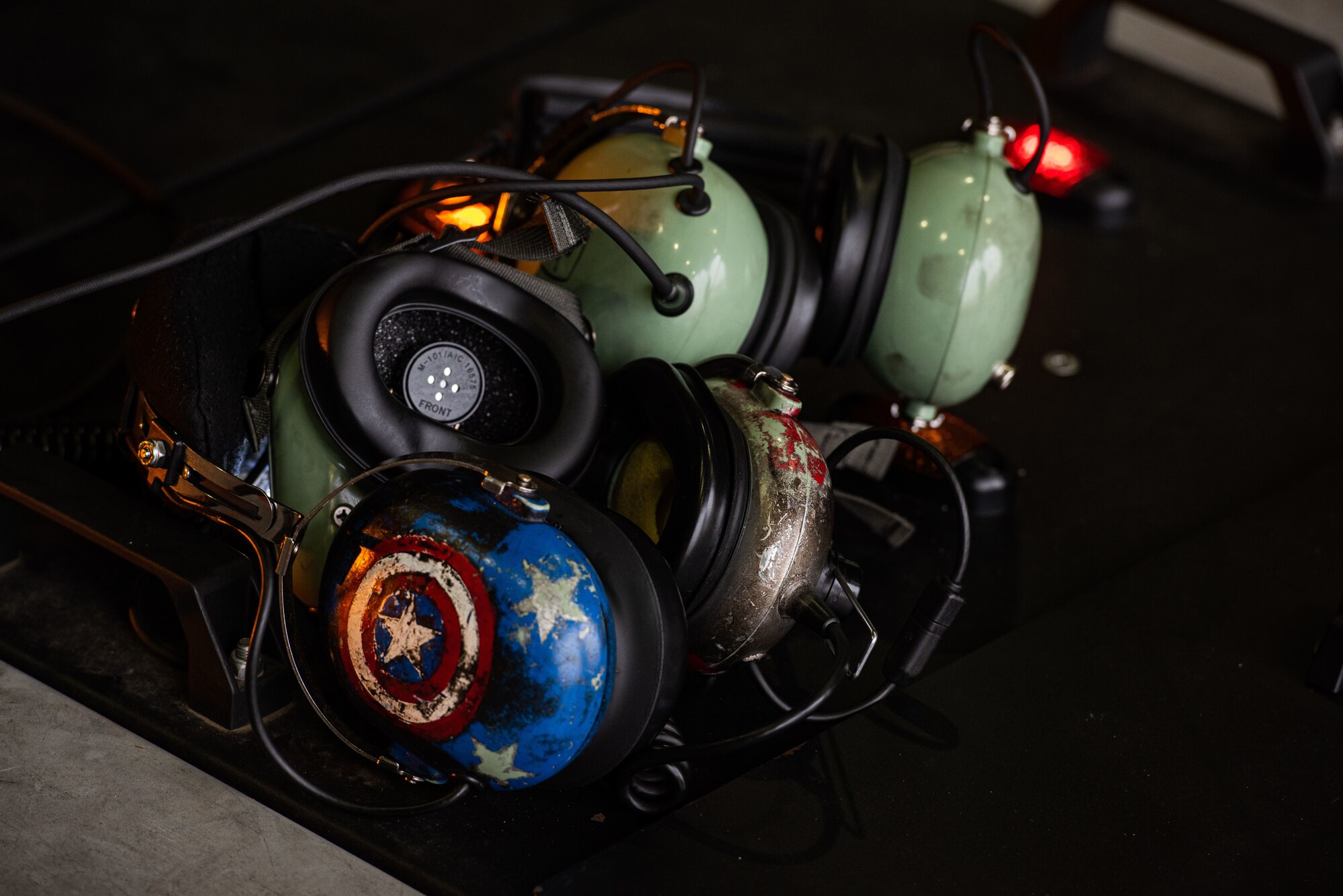 A pile of headsets rest on top of a TowFLEXX, a remote-controlled system used to mount and park aircraft, at Osan Air Base, Republic of Korea, March 18, 2022.