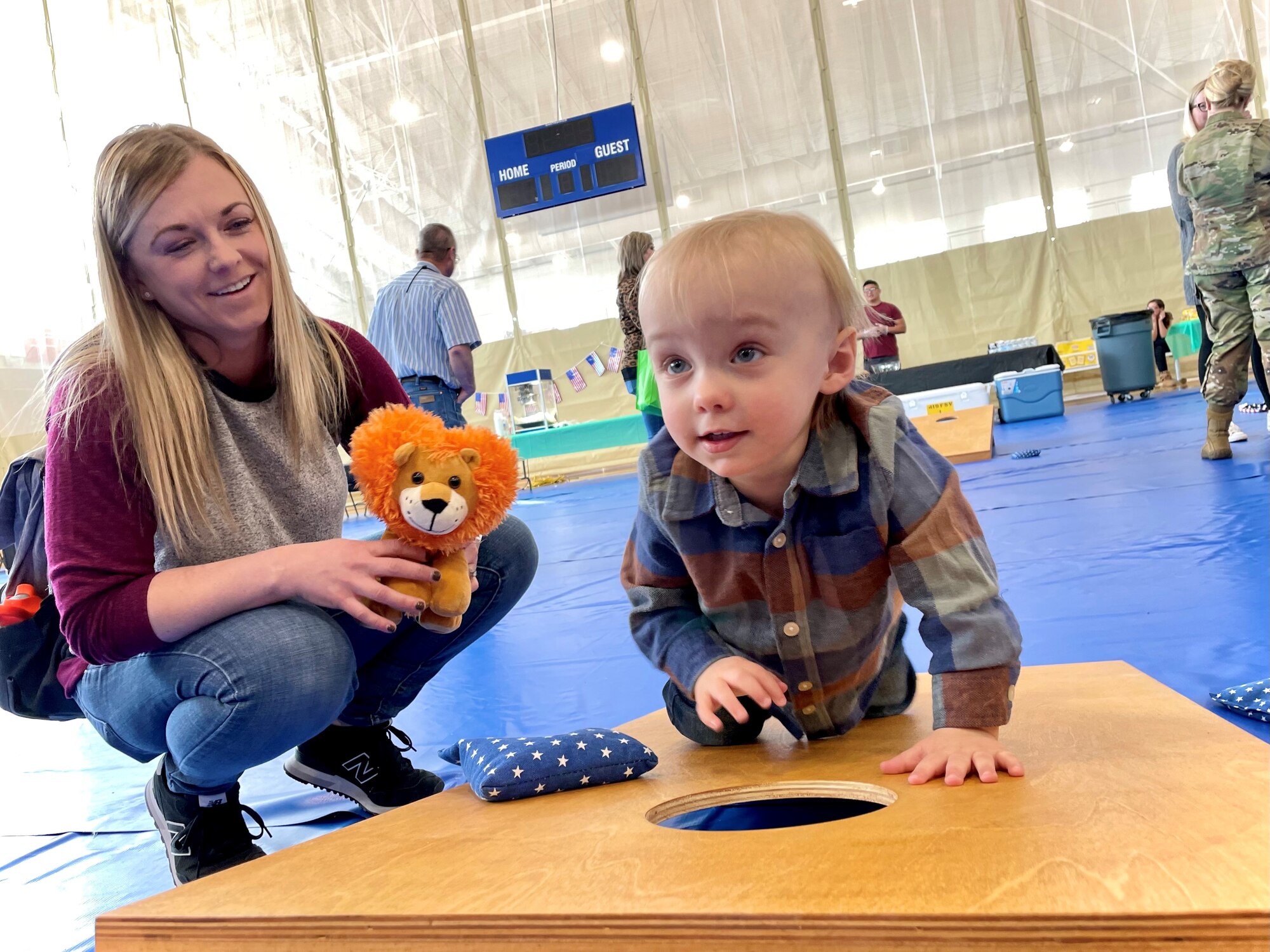 Nikki, a 419th Fighter Wing spouse, and son Carter enjoy a modified game of corn hole during an event March 19 hosted by the 419th Maintenance Group for families of deployed reservists at Hill Air Force Base, Utah