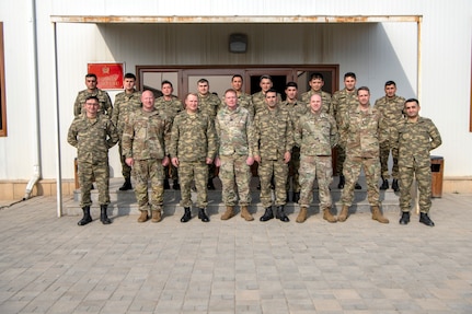 Members of the Oklahoma National Guard and the Azerbaijan Peacekeeping Brigade gather for a group photo at the conclusion of a joint partnership strategic planning and unit training management event March 3, 2022, in Baku, Azerbaijan. This is the beginning of a doctrinal training plan the Oklahoma National Guard is preparing for the Azerbaijan Peacekeeping Brigade intended to cover military decision making processes.