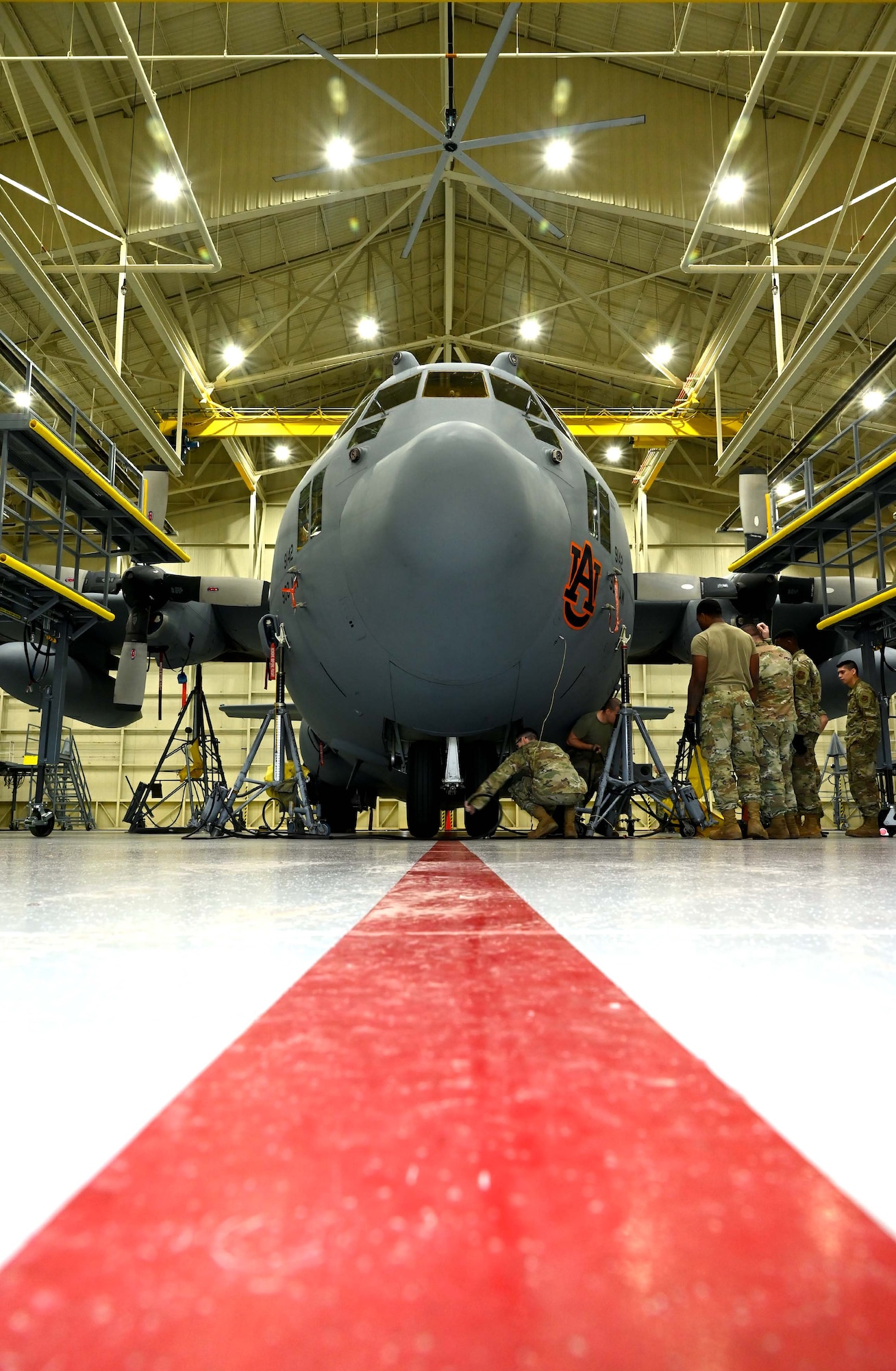 Crew chiefs from the 908th Maintenance Squadron, prepare a C-130H Hercules for an isochronal inspection