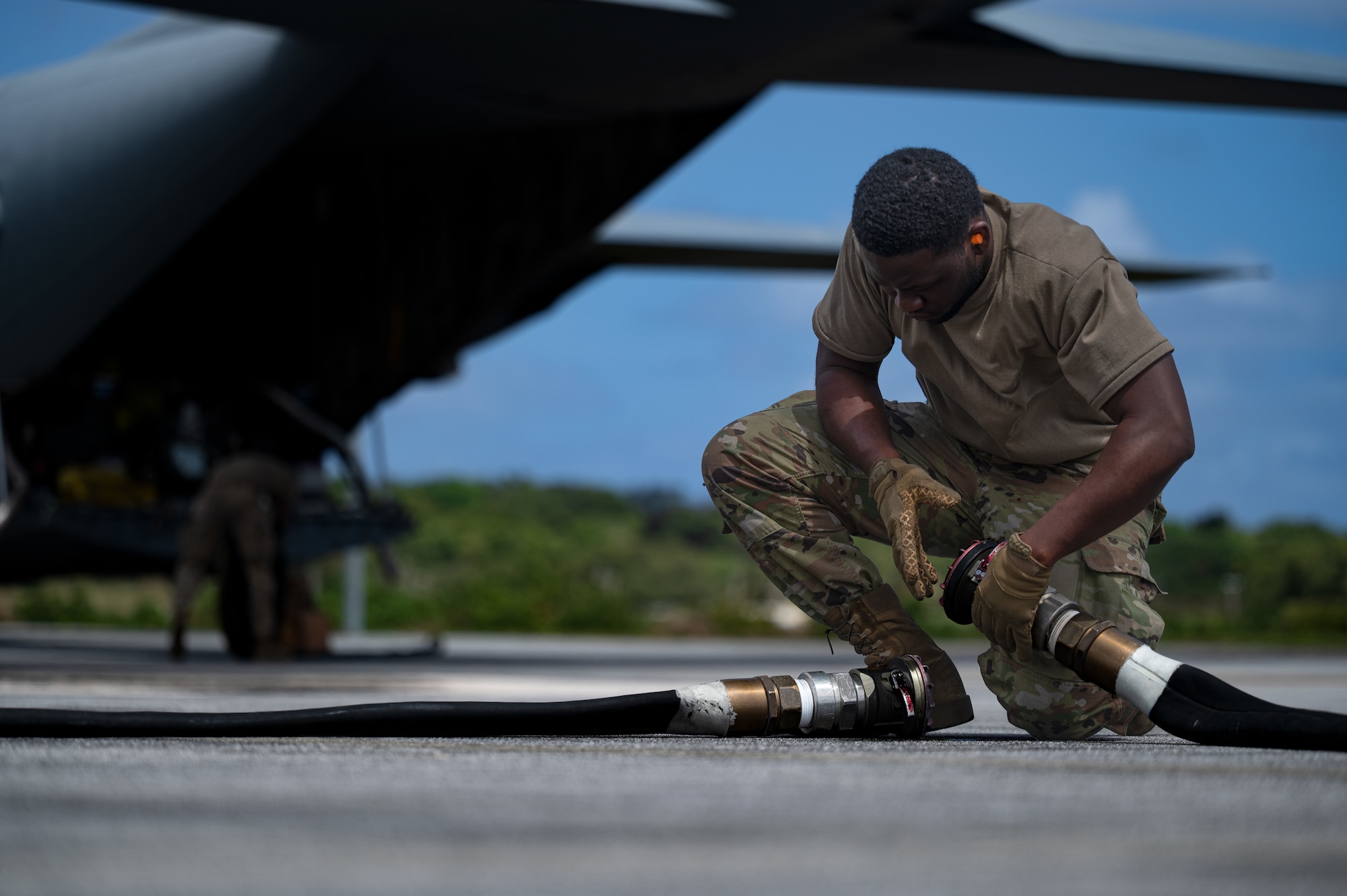 A C-130J fuels a F/A-18C Hornet during a hot pit refueling at Andersen Air Force Base, Guam, Feb. 14, 2022.