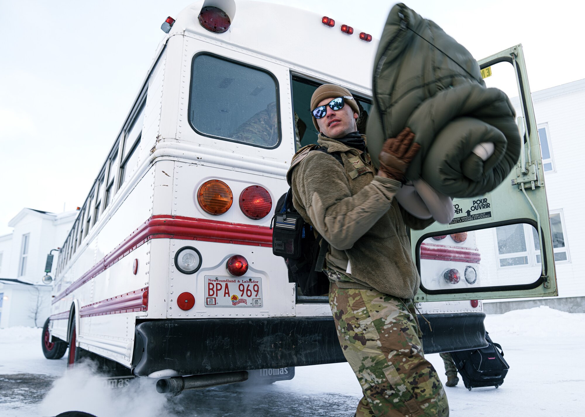 U.S. Air Force Airman 1st Class Aaron Jacobs, 6th Aircraft Maintenance Squadron maintainer, unloads gear off a bus during North American Aerospace Defense Command's (NORAD) Operation Noble Defender (OND), March 15, 2022.