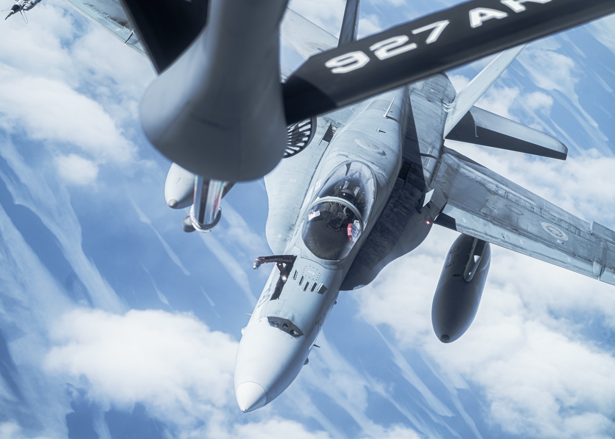 A KC-135 Stratotanker aircraft assigned to the 6th Air Refueling Wing provides aerial refueling for a CF-18 Hornet aircraft assigned to the 433rd Tactical Fighter Squadron in support of North American Aerospace Defense Command's (NORAD) Operation Noble Defender (OND), March 16, 2022.