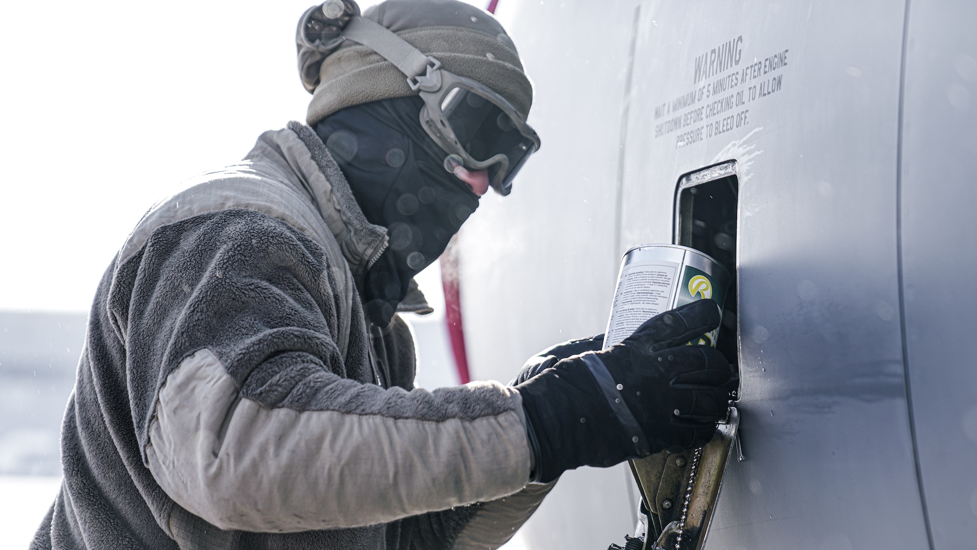U.S. Air Force Senior Airman Jeremiah Green, 6th Aircraft Maintenance Squadron crew chief, services engine oil on a KC-135 Stratotanker aircraft assigned to the 6th Air Refueling Wing during North American Aerospace Defense Command's (NORAD) Operation Noble Defender (OND), March 15, 2022.