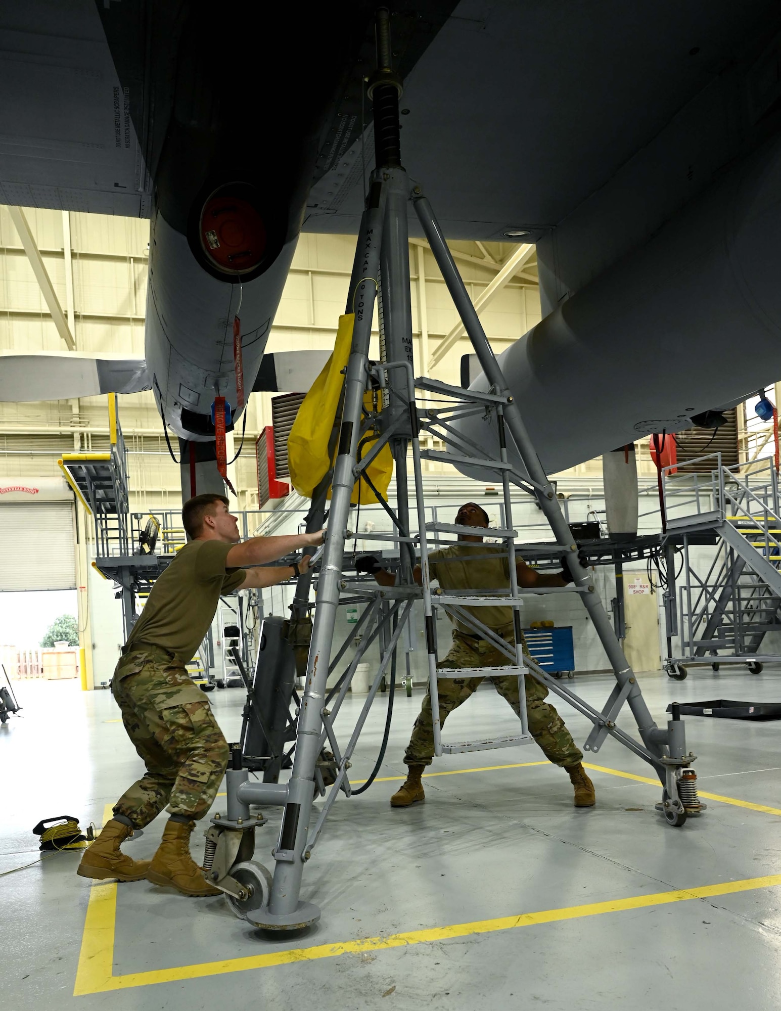 two men adjust a wing jack