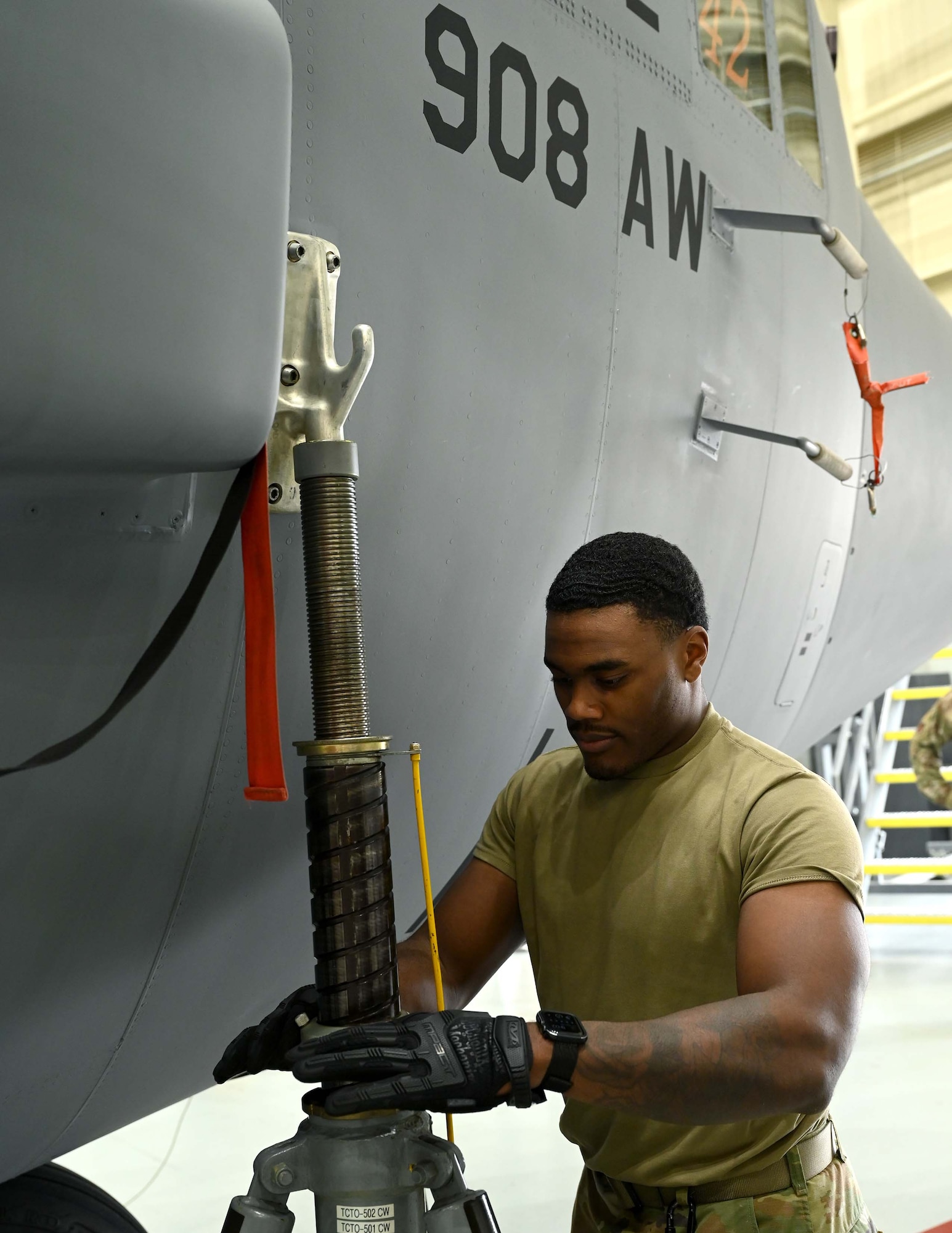 a man adjusts the ram lock on a fuselage jack